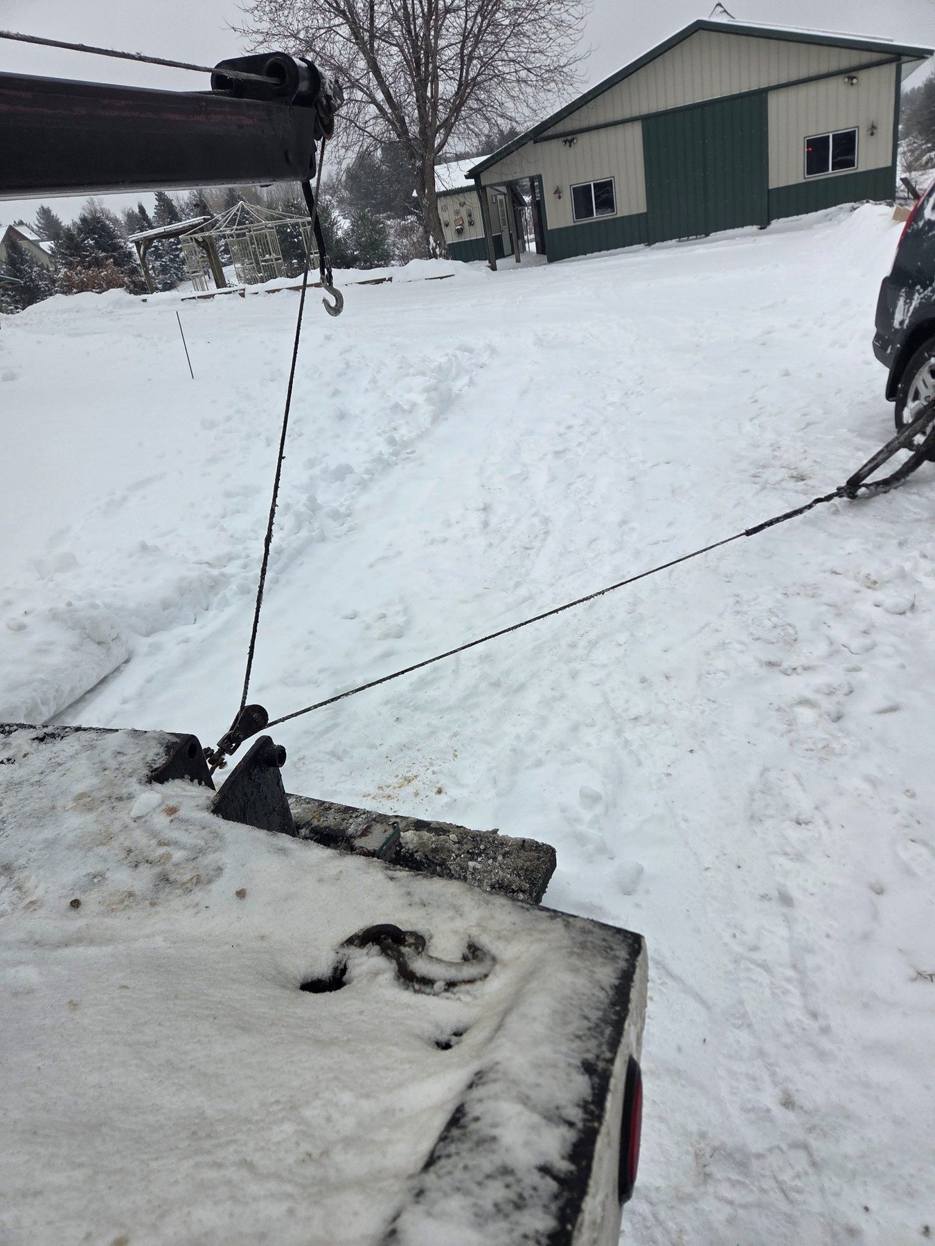 Winch line running from the tow truck during a snow recovery